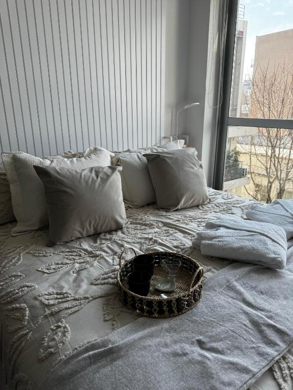 a bed with a basket on it with a window at Modern Studio in Palermo Hollywood in Buenos Aires
