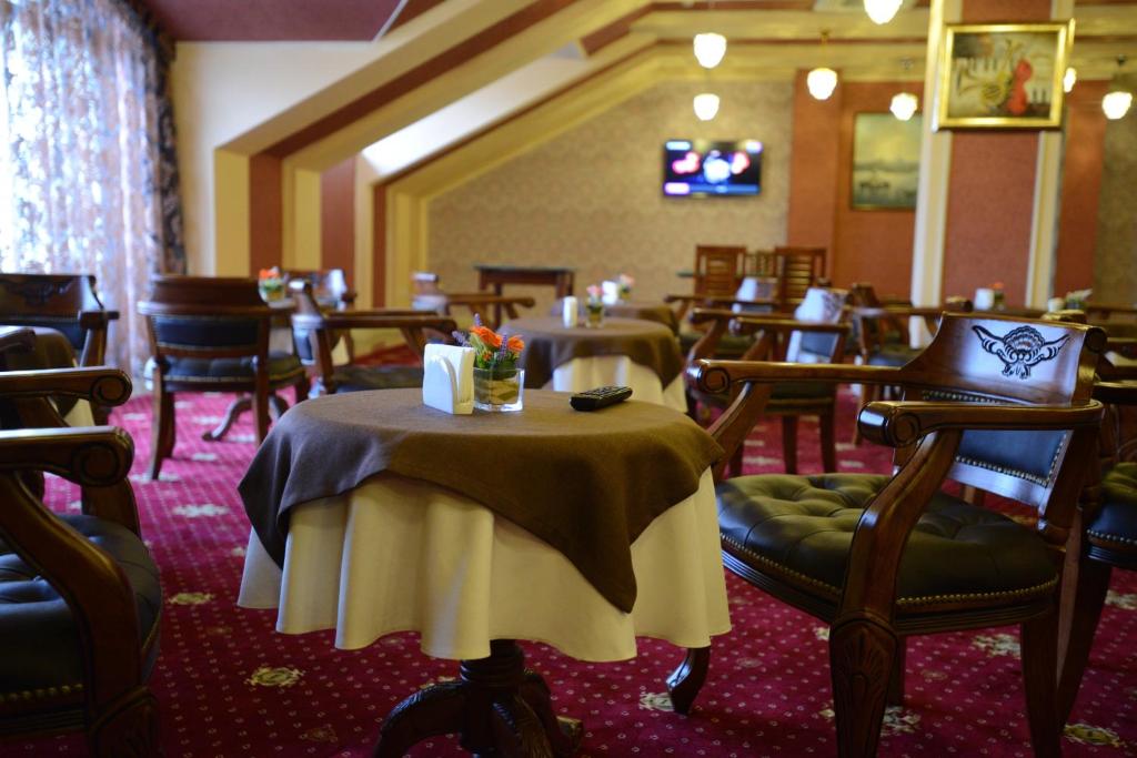 a restaurant with tables and chairs in a room at City Line Boutique Hotel in Tashkent