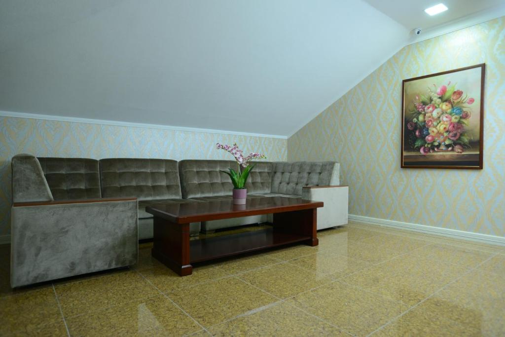 a living room with a couch and a coffee table at City Line Boutique Hotel in Tashkent