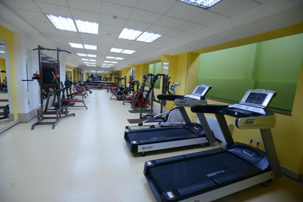 a row of treadmills in a gym with machines at City Line Boutique Hotel in Tashkent