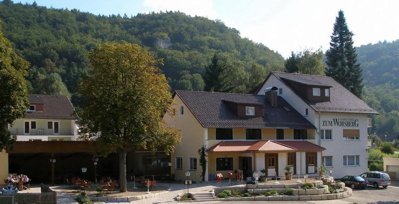 a inn in the middle of a parking lot at Landgasthof Zum Wolfsberg in Dietfurt