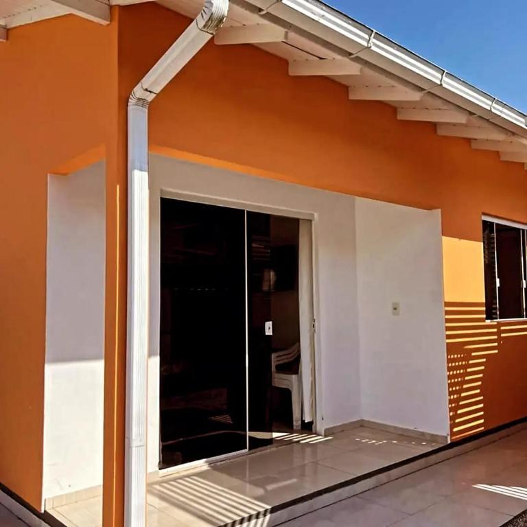 a building with a large window on the side of it at Refugio da Camboa - Casa Laranja in Armação