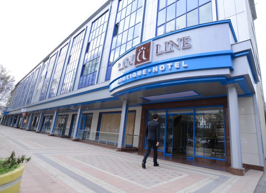 a man standing in front of a building at City Line Boutique Hotel in Tashkent