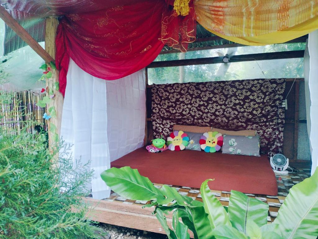 a bed in a house with stuffed animals on it at Suan's Nook Guest House in Larena