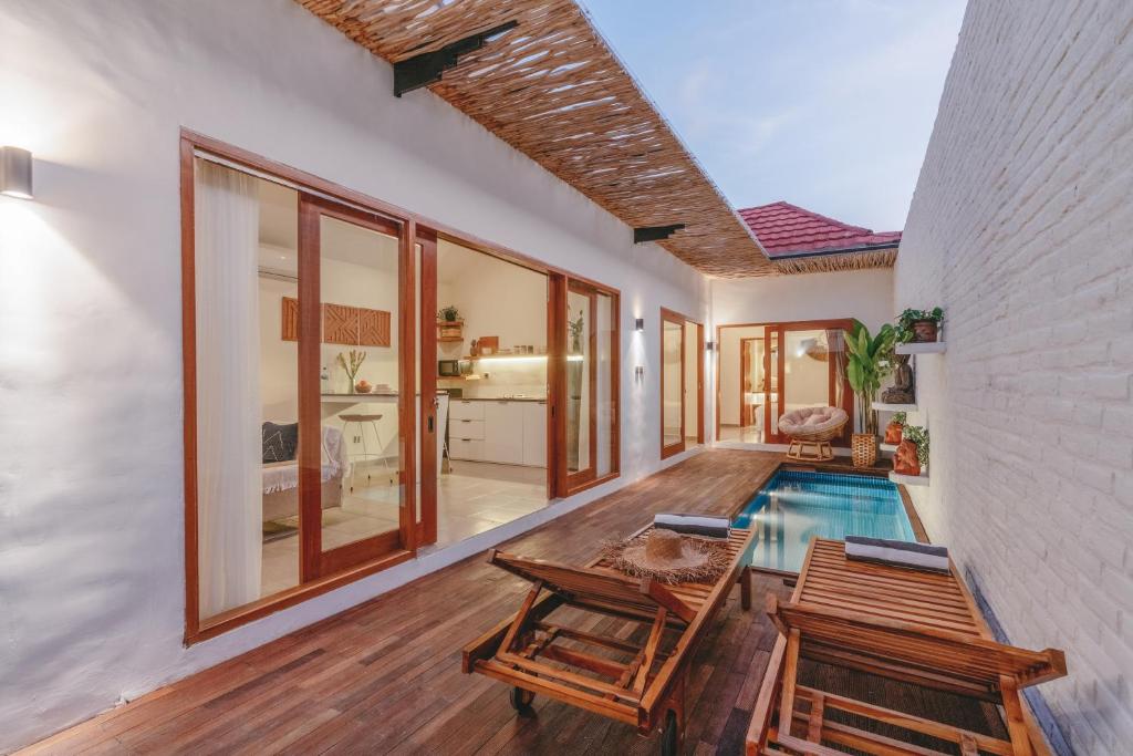 a room with a pool and a table and chairs at Senna Villa - 2BR with Private Pool in Canggu