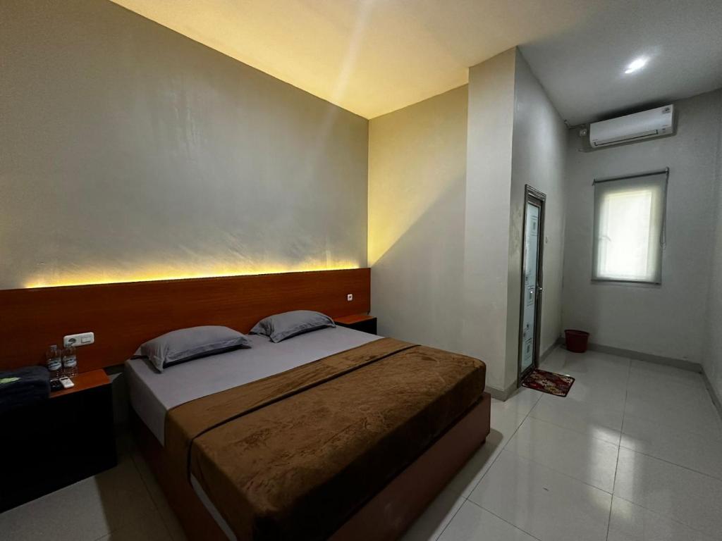 Postel nebo postele na pokoji v ubytování Grands Orchid Hotel