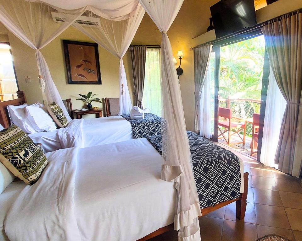 Postel nebo postele na pokoji v ubytování Mara River Safari Lodge Bali