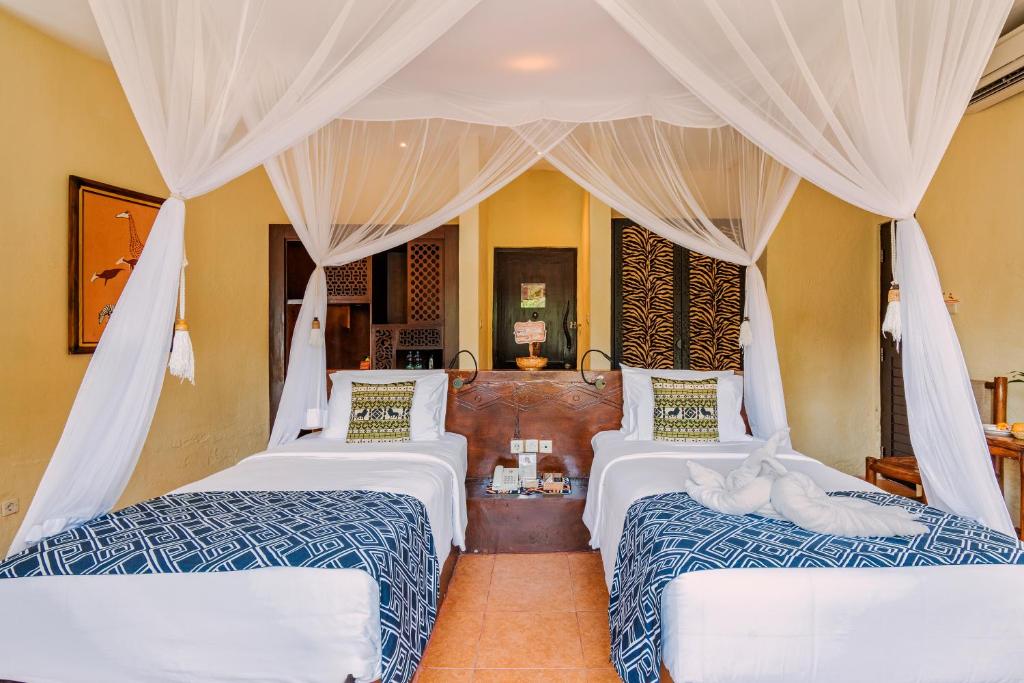 Postel nebo postele na pokoji v ubytování Mara River Safari Lodge Bali