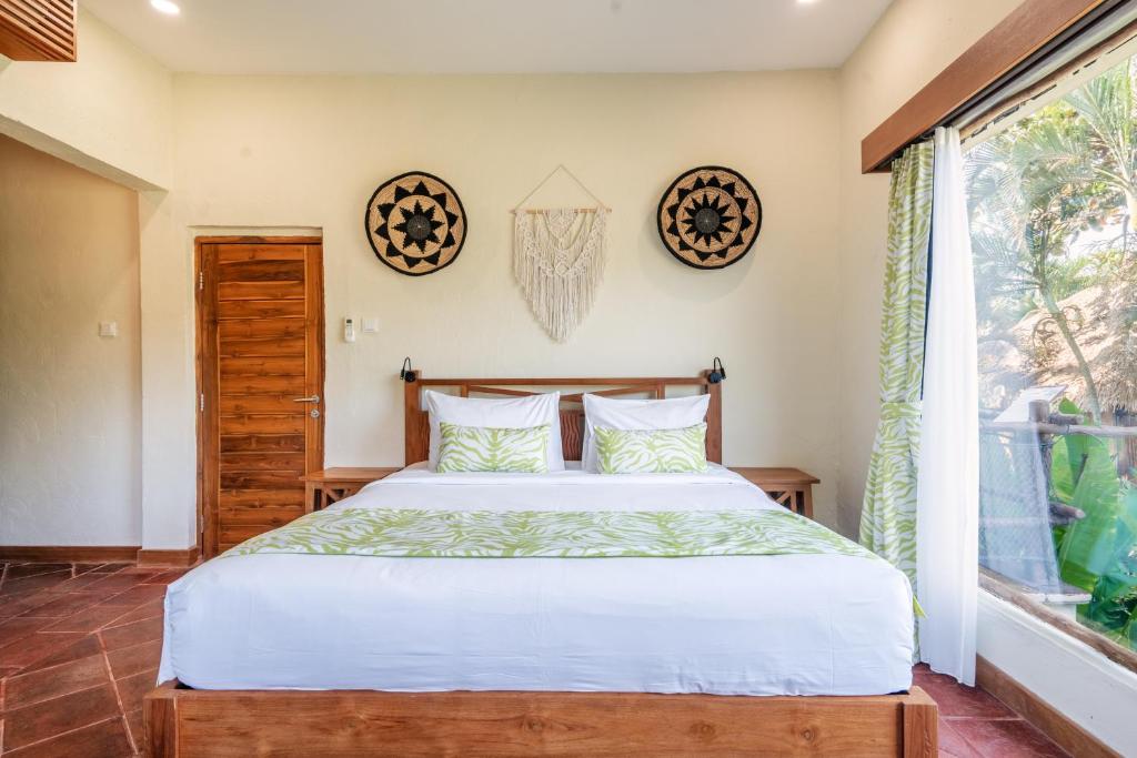 Postel nebo postele na pokoji v ubytování Mara River Safari Lodge Bali