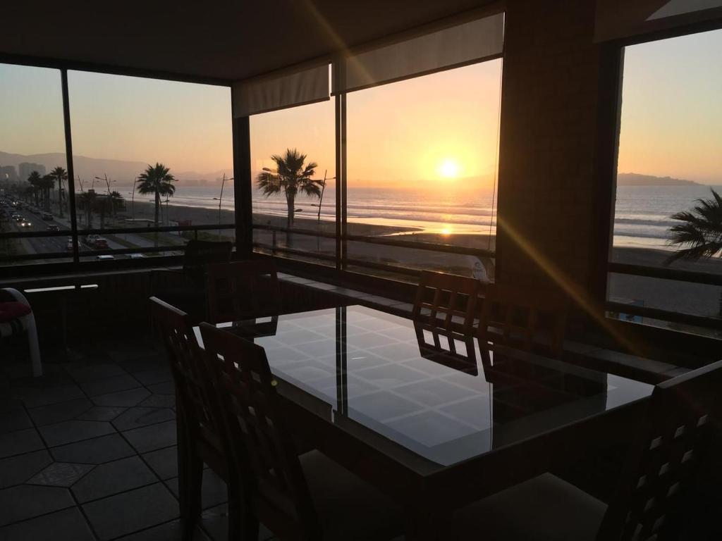 a dining room with a table and a view of the ocean at Depto Agua Marina vista al mar in La Serena