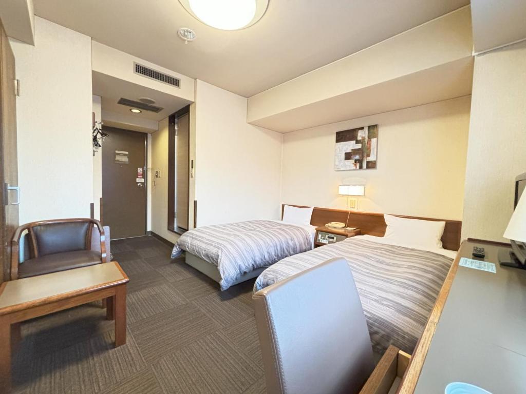 Postel nebo postele na pokoji v ubytování Hotel Route-Inn Ueda -Kokudou 18 Gou-