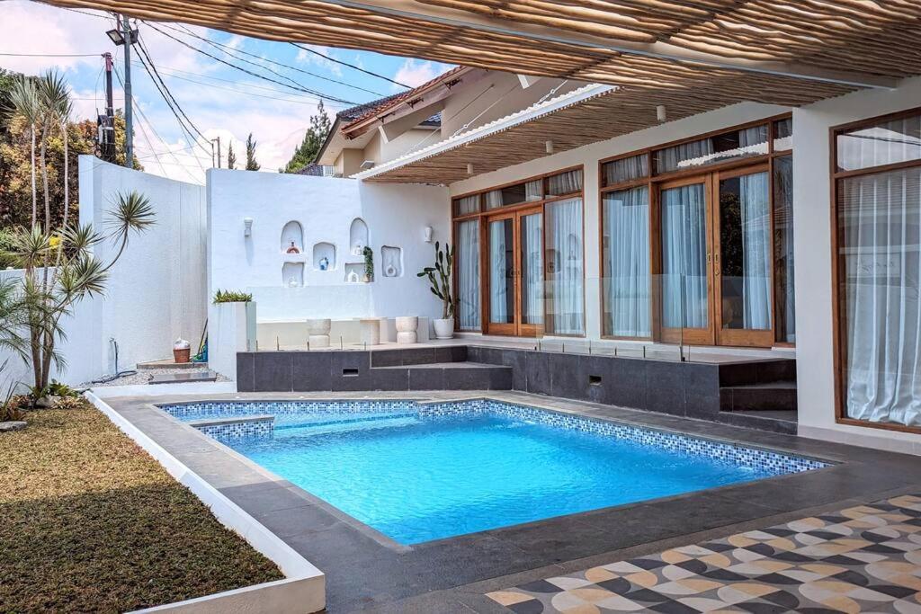 une piscine dans l'arrière-cour d'une maison dans l'établissement Cottonwood Villa Samani Pool HOT-Jacuzzi Billyard, à Bandung