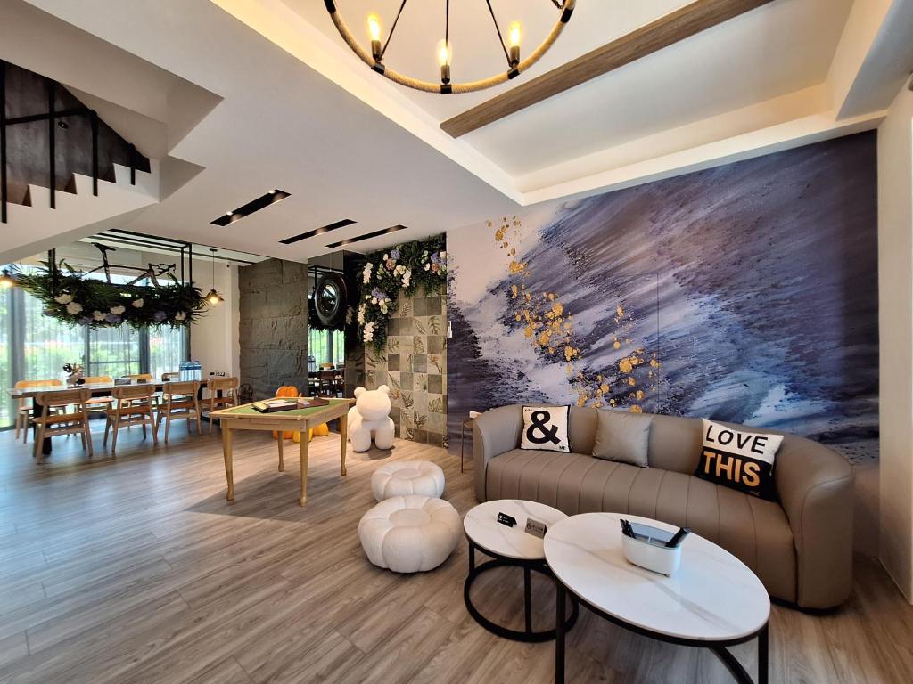a living room with a couch and tables at Villa Ten - Veg out in Guilin