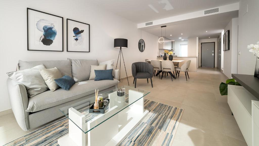 a living room with a couch and a dining room at Casa Cléoli, Mar de Pulpí, Las Amapolas in El Pozo del Esparto