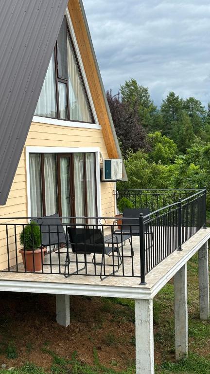 a porch with chairs and a table on a house at Cozy Cottages Kondidi in Kobuleti