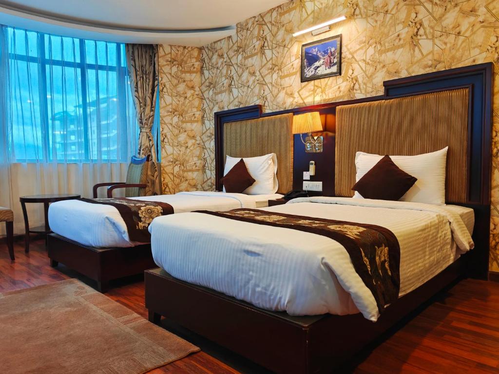 Postel nebo postele na pokoji v ubytování Hotel Mirage Regency