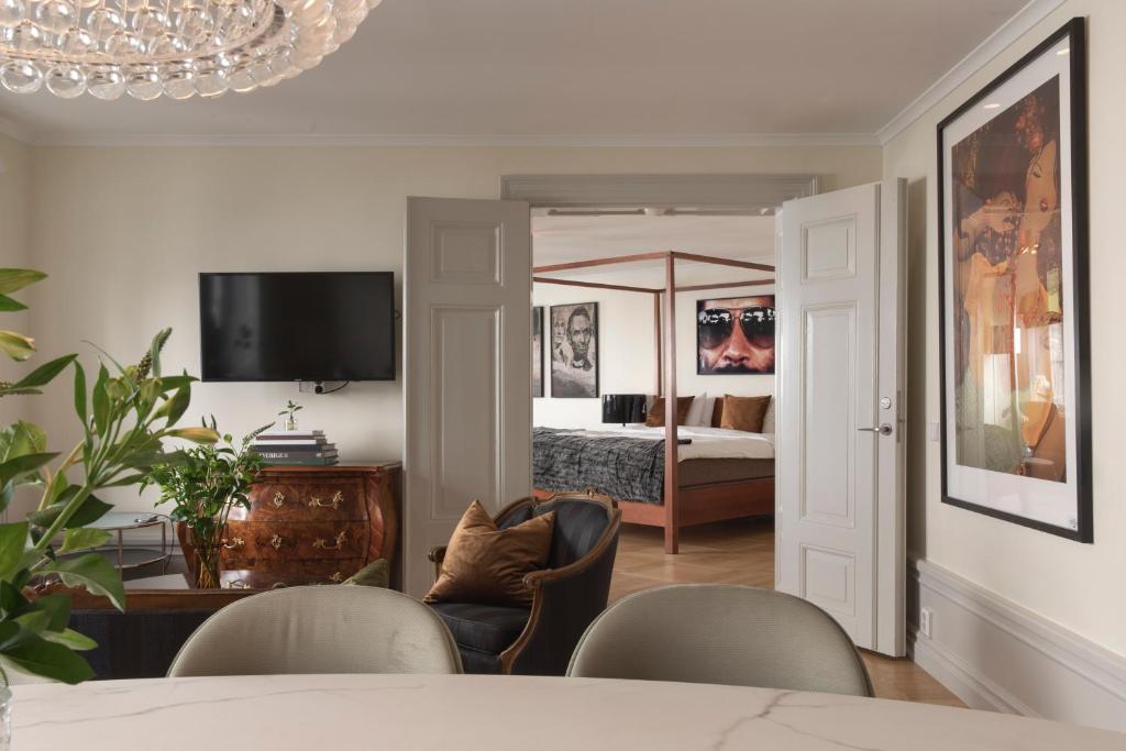 a living room with a bed and a table and chairs at Berns, Historical Boutique Hotel & House of Entertainment since 1863 in Stockholm