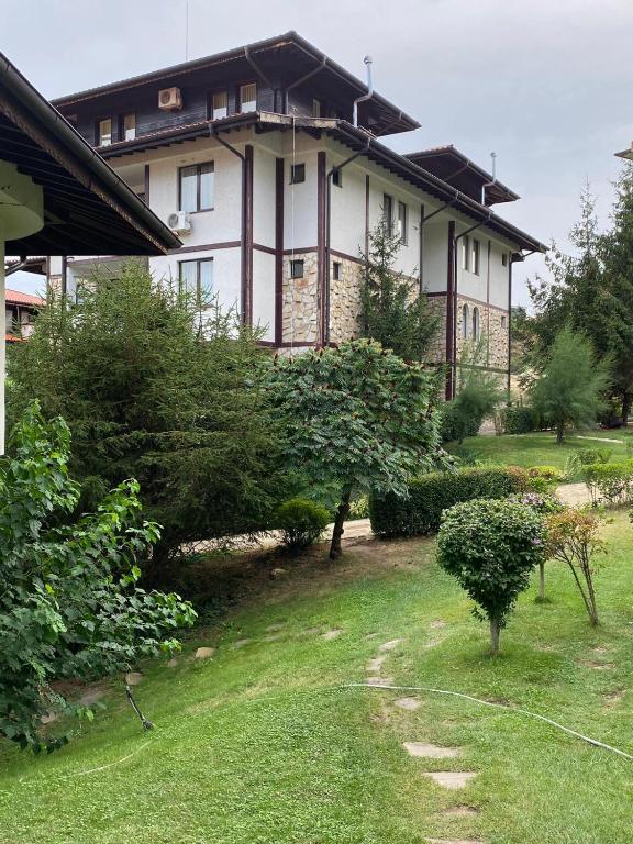 a large house with a grass yard in front of it at Etara 2 Apartment in Sveti Vlas