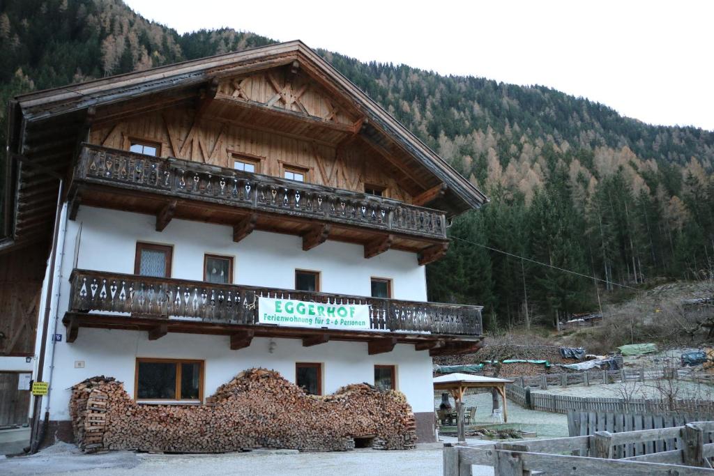 a building with a balcony on the side of it at Eggerhof in Neustift im Stubaital
