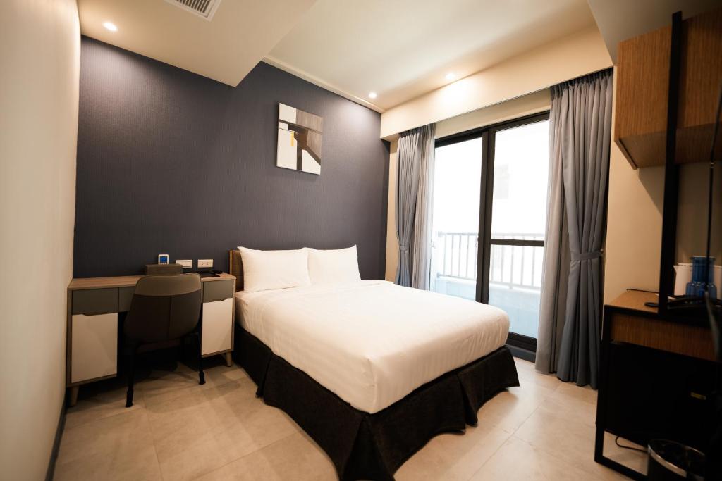 Postel nebo postele na pokoji v ubytování Chi Fong Ocean City Hotel
