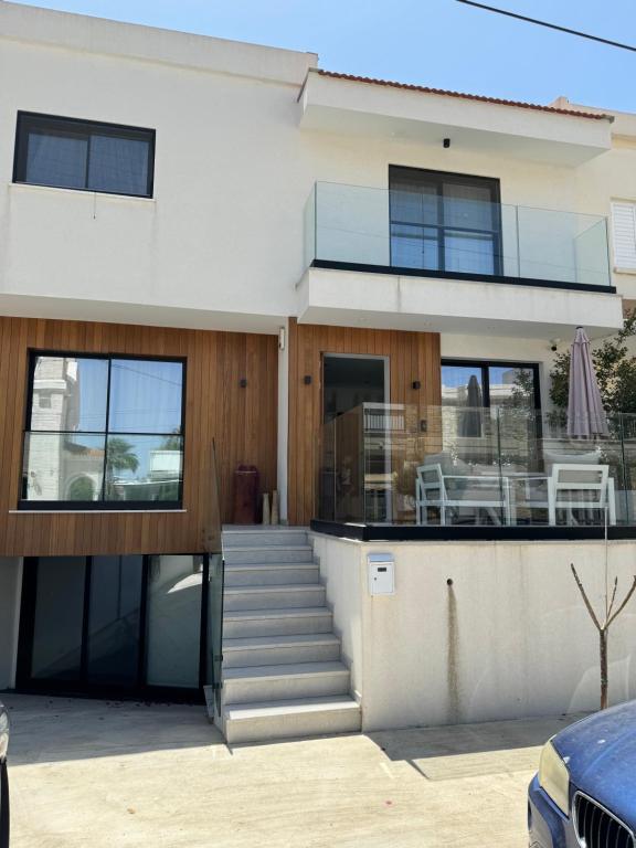a house with a staircase and a balcony at Larnaca Centre Villa in Larnaka