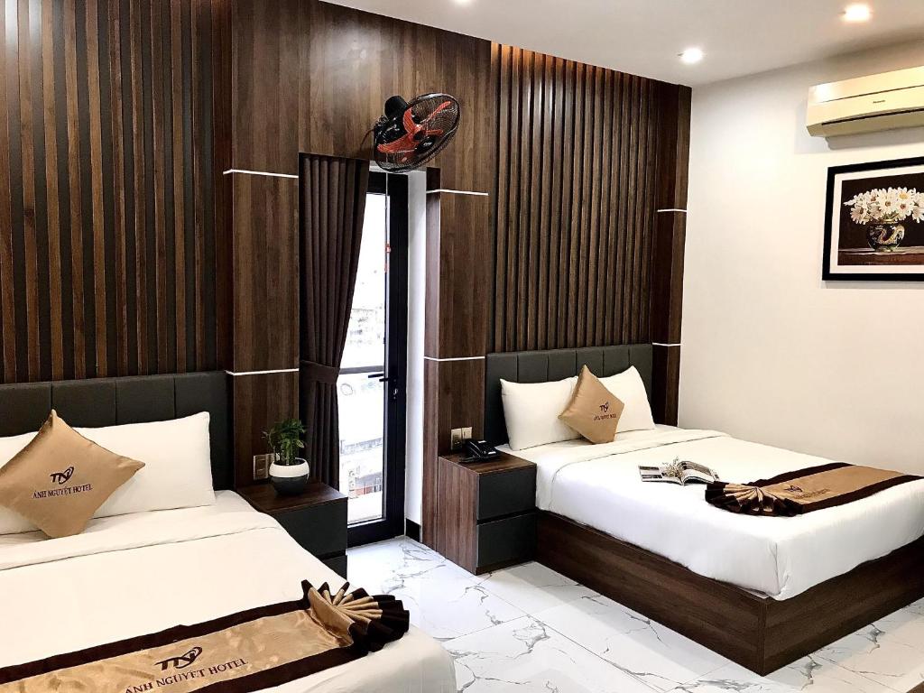 Postel nebo postele na pokoji v ubytování Anh Nguyet Da Nang Hotel