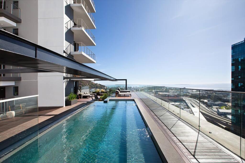 a swimming pool on the side of a building at Modern 14th floor Apt with Balcony & Mountain Views at 16onBree in Cape Town