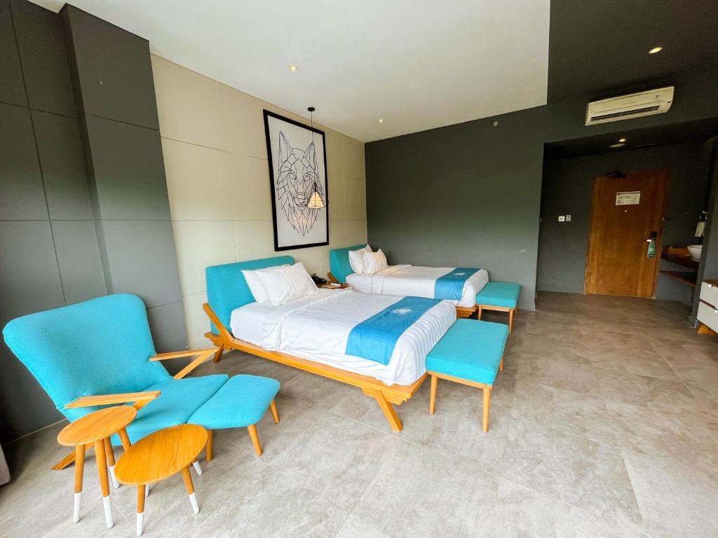 Postel nebo postele na pokoji v ubytování Hotel Dafam Wonosobo