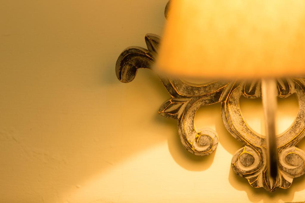 a close up of a gold light on a wall at Wei Sen House in Hualien City