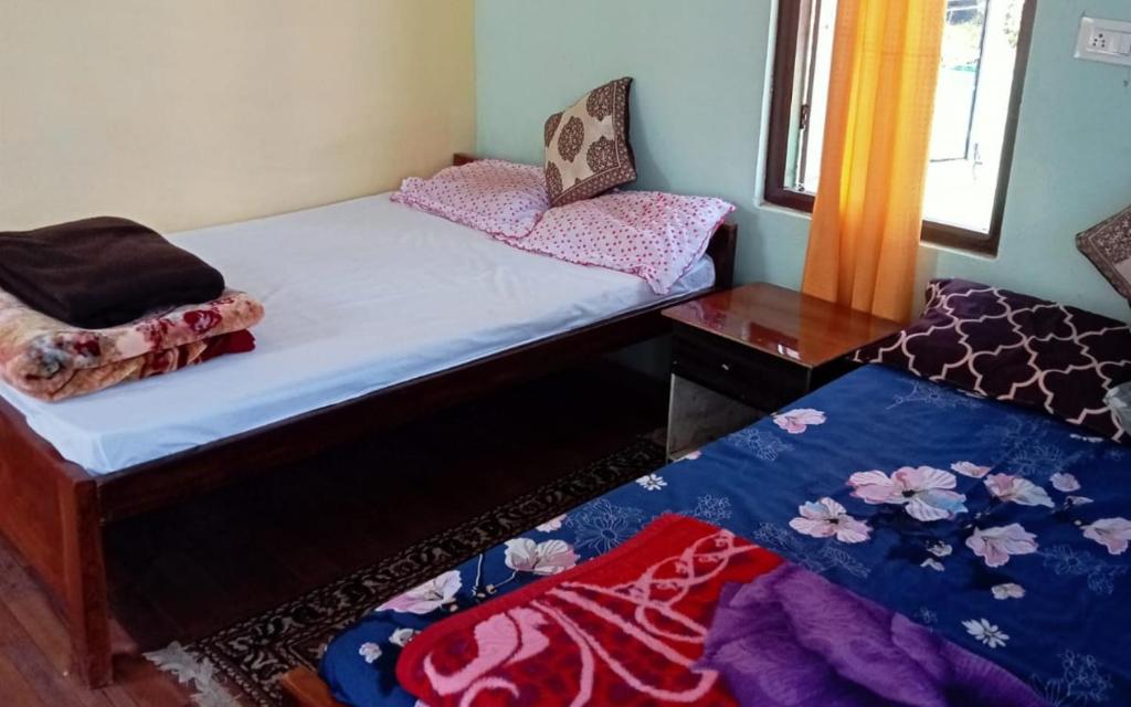 Postel nebo postele na pokoji v ubytování Green Wings Homestays by StayApart , Zoom , West Sikkim