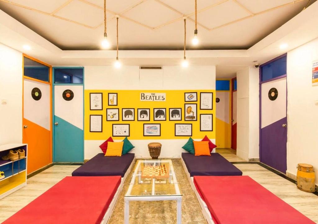 a room with colorful dividers and a table at ZoukStayz in Rishīkesh