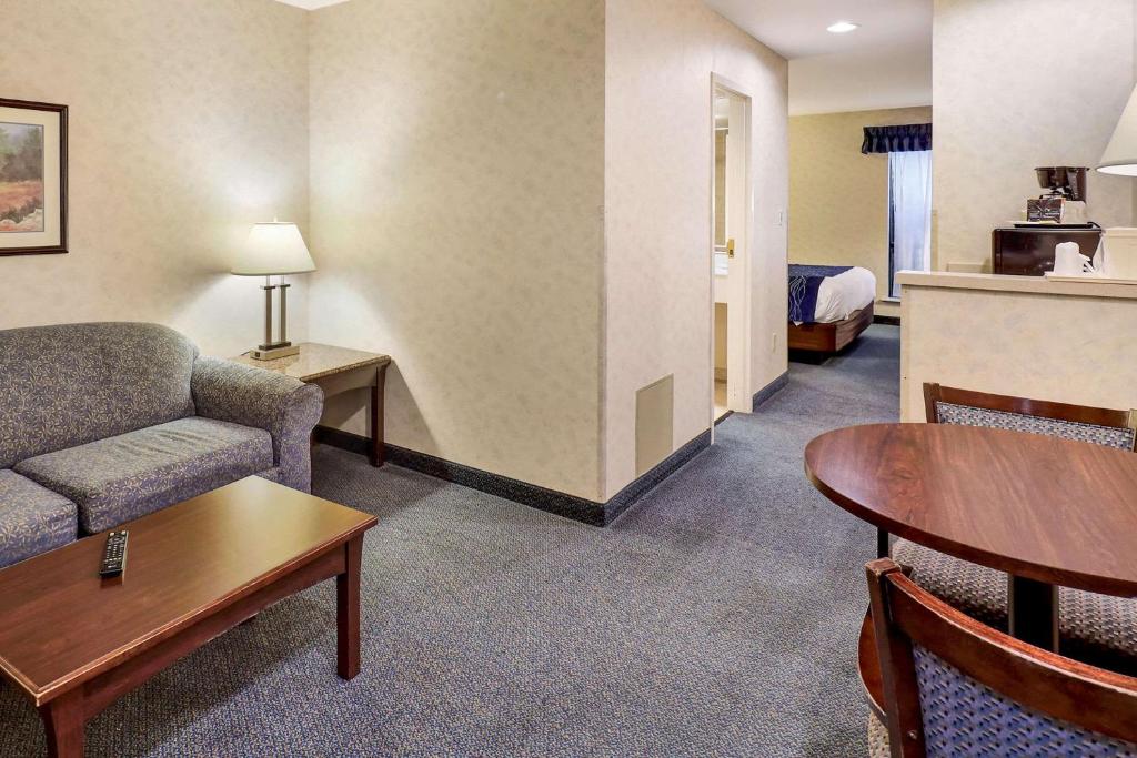 a hotel room with a couch and a table and a bed at Comfort Inn Bellingham in Bellingham