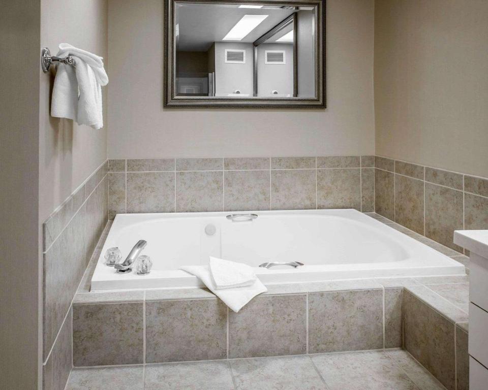 a bath tub in a bathroom with a mirror at Comfort Inn Bellingham in Bellingham