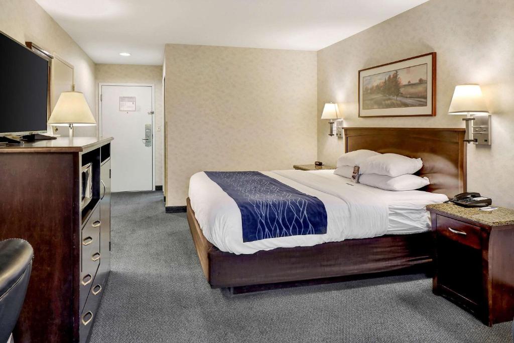a hotel room with a bed and a flat screen tv at Comfort Inn Bellingham in Bellingham