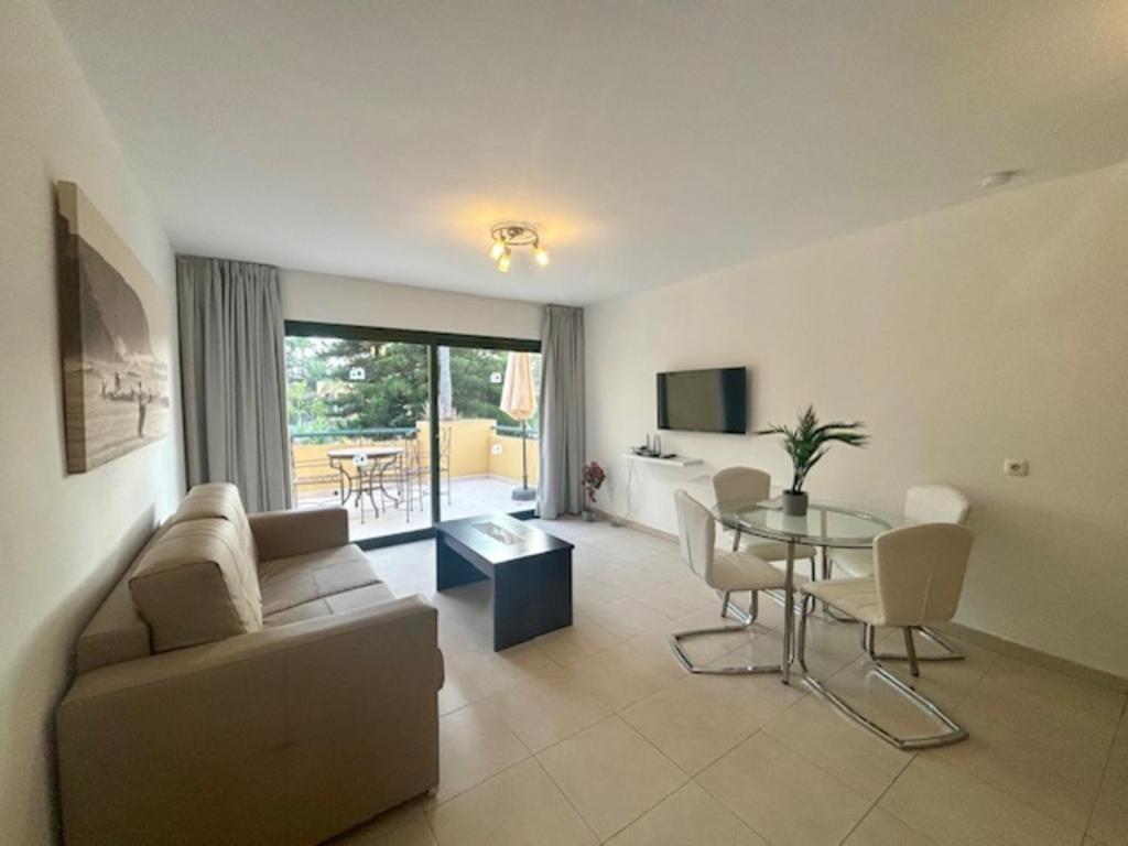 a living room with a couch and a table at Fuerteventura Atlantic Gardens Corralejo in Corralejo