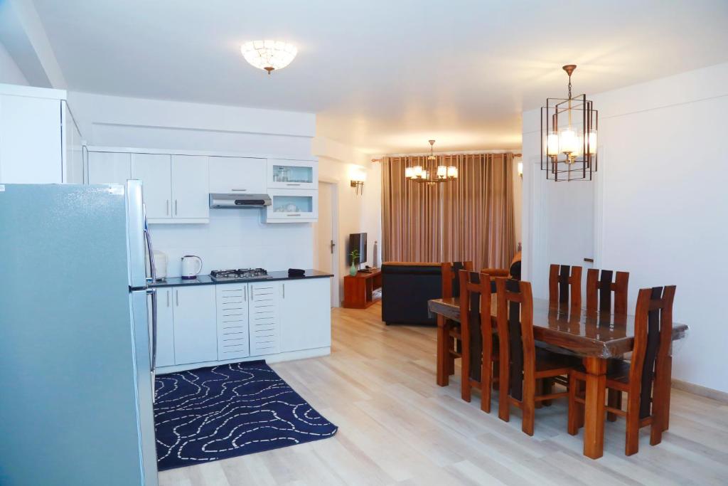 a kitchen and dining room with a table and chairs at Ajymth Luxury Apartments - Lakeview Residencies - F24 in Nuwara Eliya