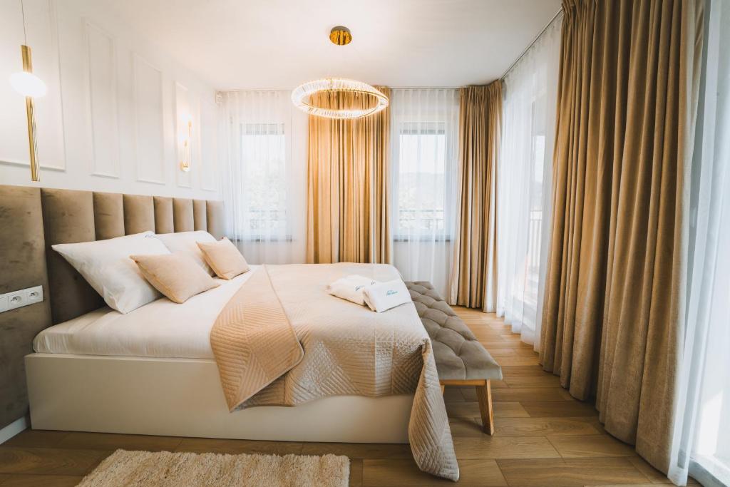 扎科帕内VisitZakopane - Gold Krupówki Inn Apartment的一间带大床和吊灯的卧室