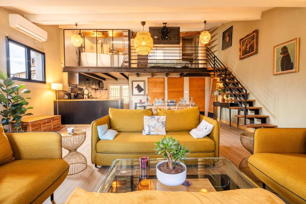 a living room with two couches and a staircase at Loft COSY et luxueux, HYPER-CENTRE in Aix-en-Provence