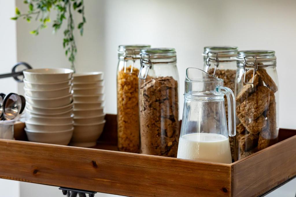 a wooden tray with jars and plates and milk at Carrick Gate in Carrick