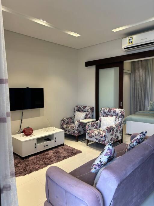 a living room with a couch and chairs and a tv at Hawana Salalah Resort - Acacia 51 in Ma‘mūrah