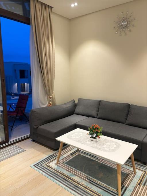 a living room with a couch and a coffee table at Hawana Salalah Resort - Riviera 5 in Ma‘mūrah