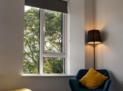 a living room with a chair and a window at Carrick Gate in Carrick