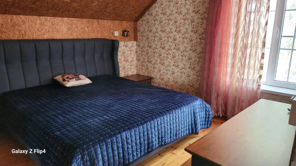 a bedroom with a bed with a dog pillow on it at Pine house in Gürgan