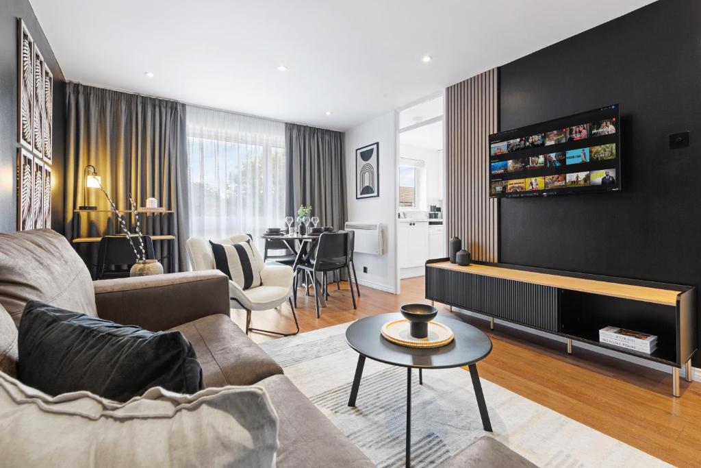 a living room with a couch and a table at 2BR Sleeps 5 With Workspace Free Wifi & Parking in Finchley