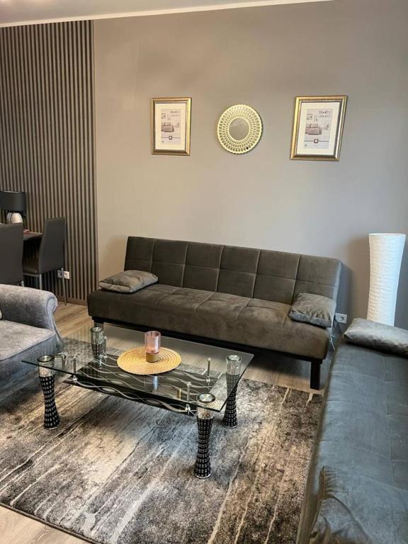 a living room with a couch and a coffee table at Appartements Bel Lago Bestensee in Bestensee