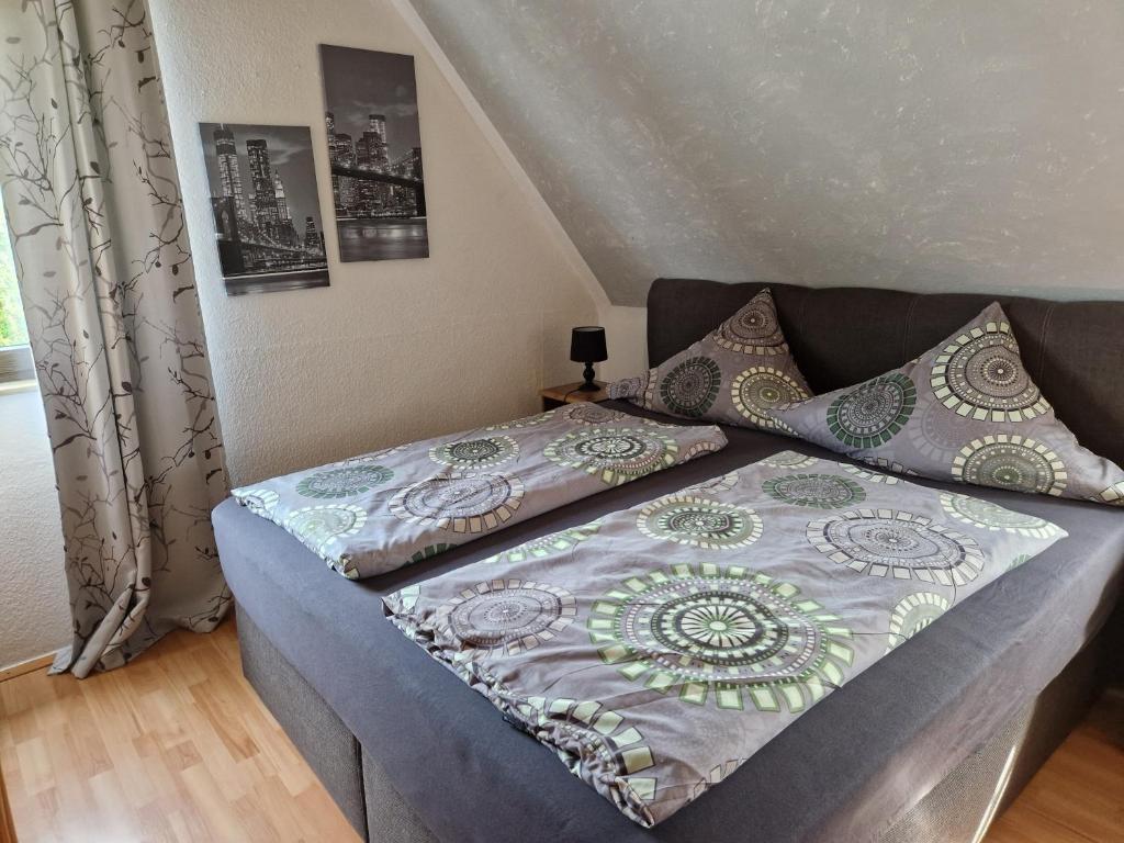 a bed with a quilt on it in a bedroom at Ferienwohnung Parkblick Medebach in Medebach