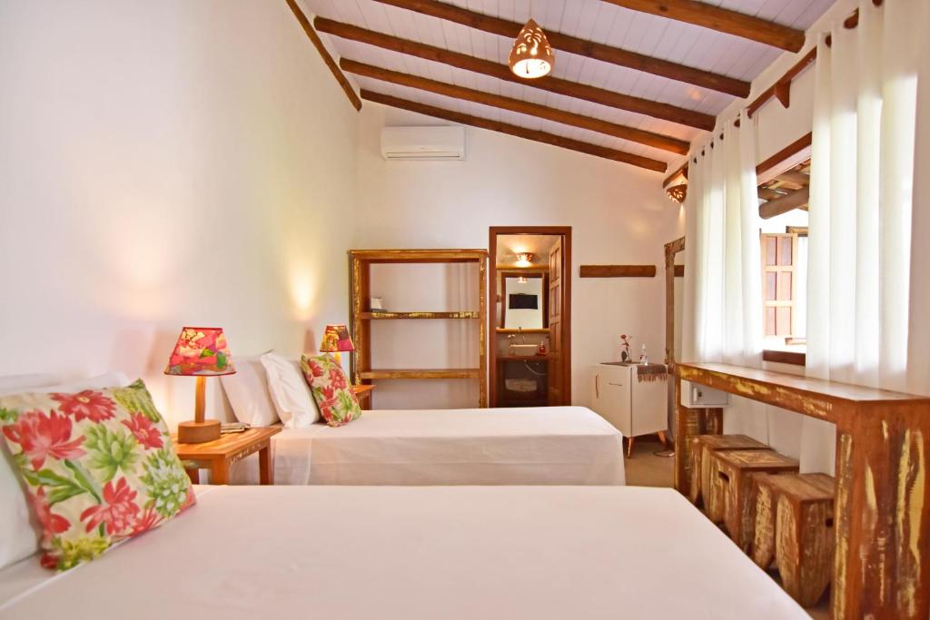 Postel nebo postele na pokoji v ubytování Casa de Paixão Caraíva