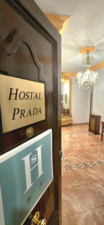 a sign on a door to a hospital plaza at Hostal Prada in Madrid