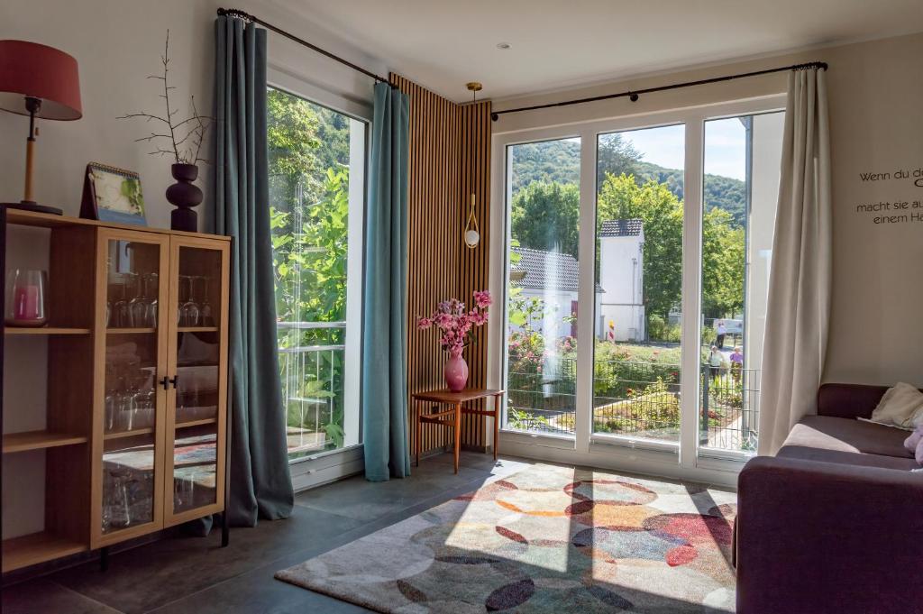 a living room with a large sliding glass door at Ferienwohnung Wurzelecht in Bad Neuenahr-Ahrweiler