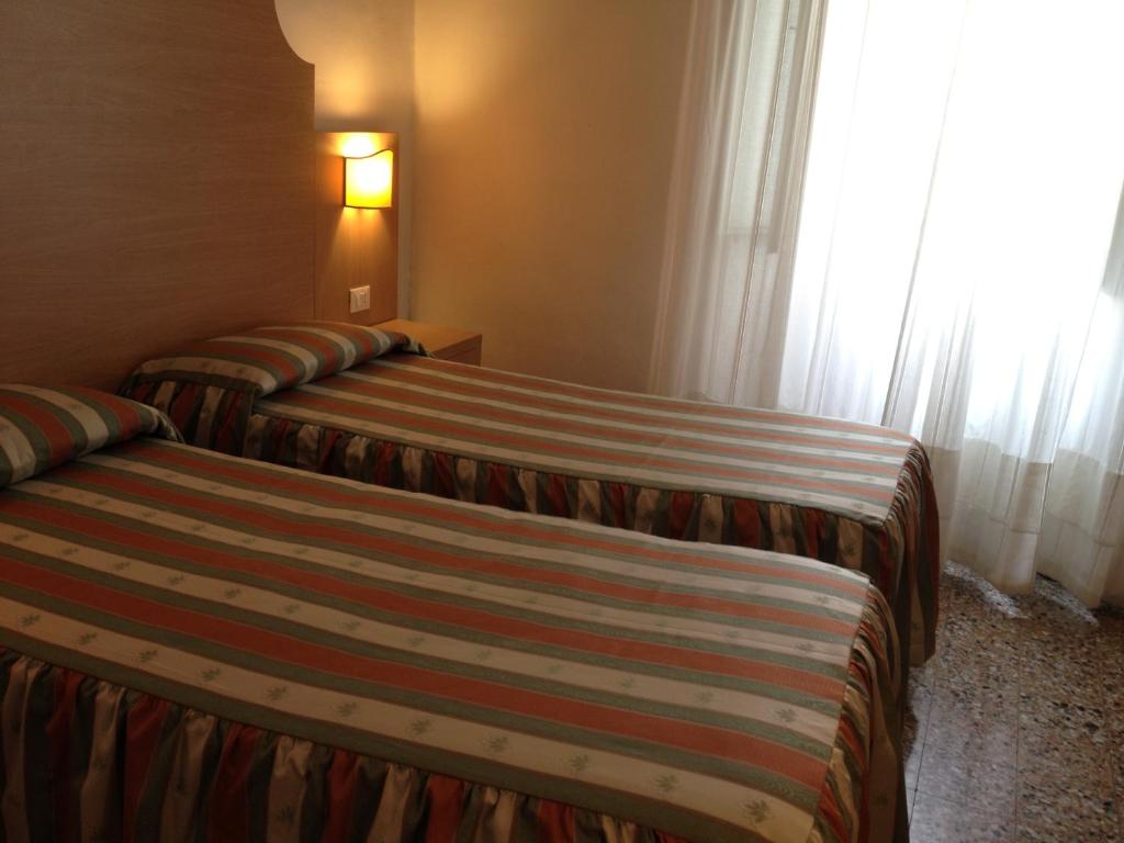 Postel nebo postele na pokoji v ubytování Albergo Giugni